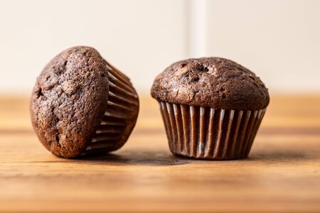 Sweet muffins. Chocolate cupcakes on kitchen table.の写真素材