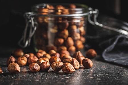 Peeled hazelnuts on old kitchen table.の写真素材