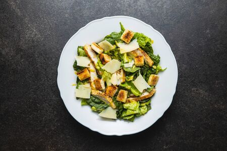 Chicken Caesar Salad with Cheese and Croutons on plate. Top view.の写真素材