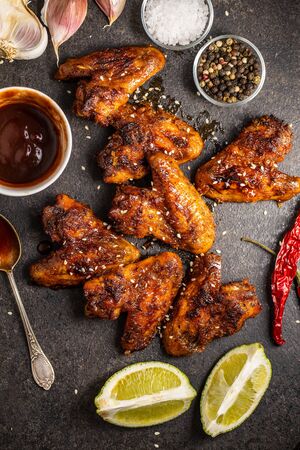 Grilled chicken wings on black rustical table.の写真素材