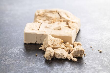 Fresh yeast blocks on black kitchen table.の写真素材