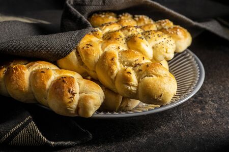 Tasty braided buns on black kitchen table.の写真素材