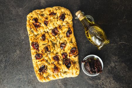 Homemade Italian Focaccia. Traditional Italian pastries with dried tomatoes and olive oil. Top view.の写真素材