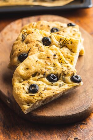 Homemade Italian Focaccia. Traditional Italian pastries with olives on wooden table.の写真素材