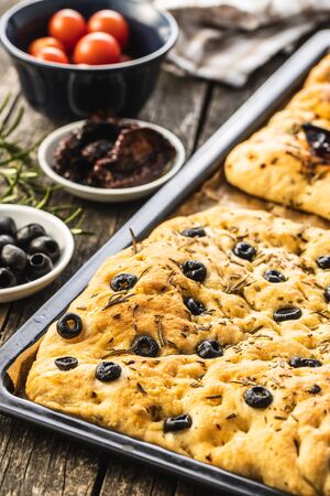 Homemade Italian Focaccia. Traditional Italian pastries with black olives.の写真素材