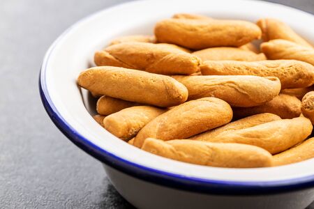 Mini bread sticks in bowl.