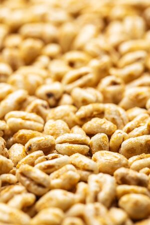 Puffed wheat covered with honey. Pattern of healthy cereals.の写真素材