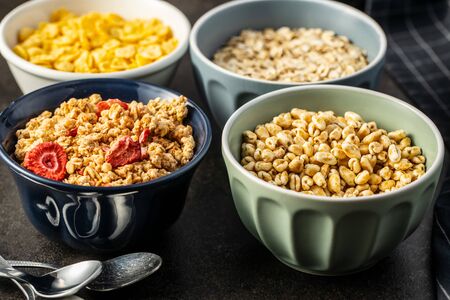 Various breakfast cereals in bowls. Puffed wheat and oatmeals.の写真素材