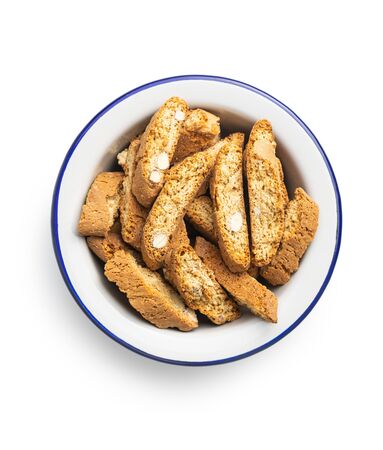 Sweet italian cantuccini cookies. Almonds biscuits in bowl isolated on white background.の写真素材