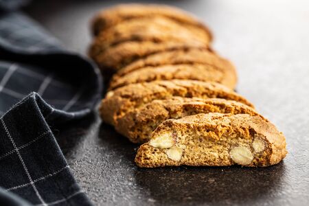 Sweet italian cantuccini cookies. Almonds biscuits on black table.の写真素材