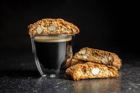 Sweet italian cantuccini cookies. Almonds biscuits and coffee cup on black table.の写真素材