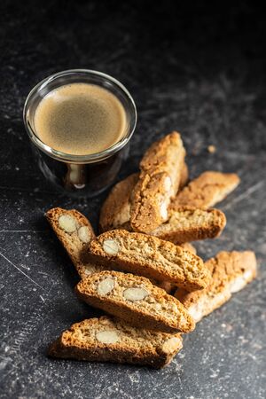 Sweet italian cantuccini cookies. Almonds biscuits and coffee cup on black table.の写真素材