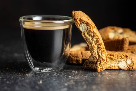 Sweet italian cantuccini cookies. Almonds biscuits and coffee cup on black table.の写真素材