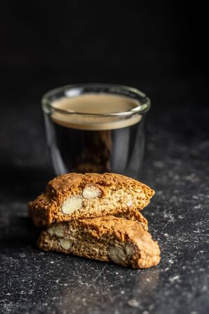 Sweet italian cantuccini cookies. Almonds biscuits and coffee cup on black table.の写真素材