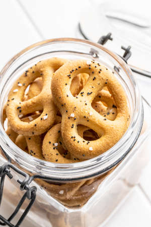 Crispy salted pretzels in jar.
