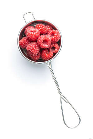 Ripe red raspberries in strainer isolated on white background.