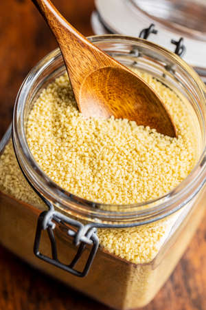 Dry yellow couscous in jar.の写真素材