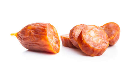 Sliced mini salami sausages isolated on white background.の写真素材