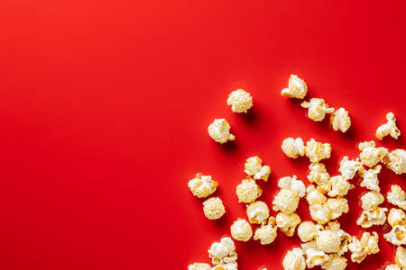 Sweet tasty popcorn on red background. Top view.の写真素材