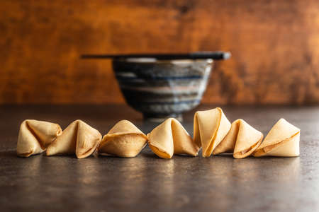 Chinese lucky cookies. Fortune cookies on black table.の写真素材