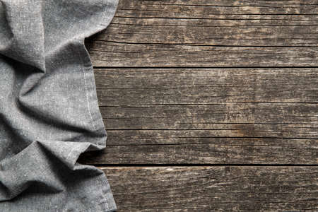 Folded tablecloth over antique wooden table. Top view.の写真素材