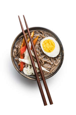 Asian noodle soup with soba noodles, vegetable and egg in bowl isolated on white background.の写真素材