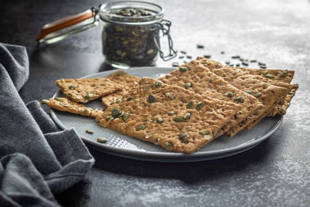 The crispy bread with pumpkin seeds. Knackebrot on plate.の写真素材