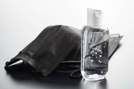 Antibacterial hand gel and black face mask. Coronavirus protection.の写真素材