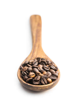 Roasted coffee beans on wooden spoon isolated on white background.の写真素材