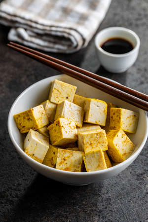 Dices of marinated tofu in bowl.の写真素材
