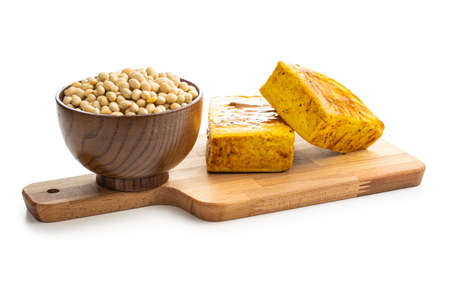 Dices of marinated tofu and soy beans isolated on white background.