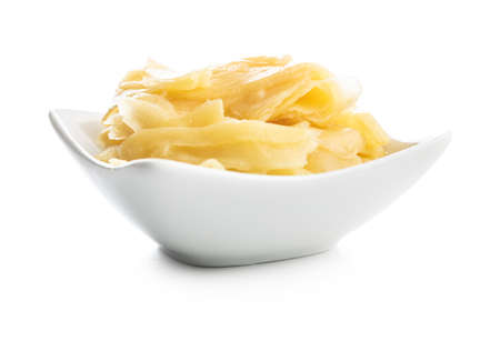 Pickled sushi ginger slices in bowl isolated on white background.の写真素材