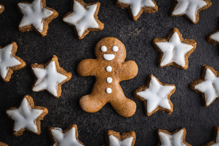 Xmas gingerbread man on black table. Top view.