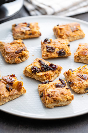 Crunchy cereal cookies with nuts and raisins on plate.の写真素材