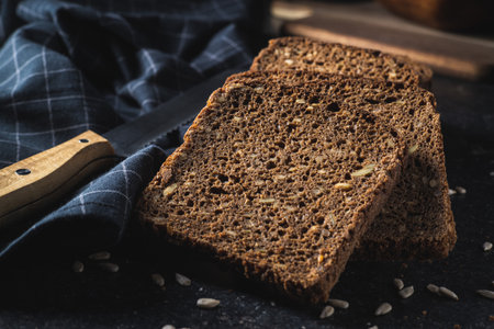 Dieting cereal bread with sunflower seeds on black table.の写真素材
