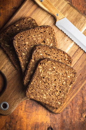 Dieting cereal bread with sunflower seeds on wooden table. Top view.