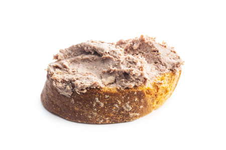 Liver pate on sliced baguette isolated on white background.の写真素材