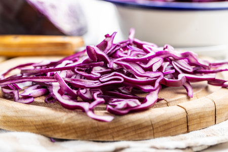 Sliced fresh red cabbage on cutting board.の写真素材