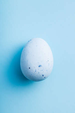 Blue chocolate easter egg. Sweet candy egg on a blue background. Top view.の写真素材