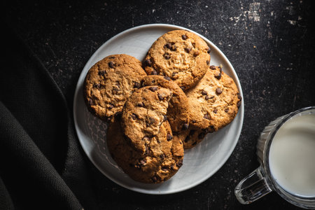Tasty biscuits with chocolate. Sweet chocolate cookies on plate. Top view.の写真素材