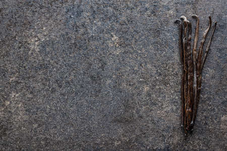 Vanilla pods. Sticks of vanilla on black table. Top view.