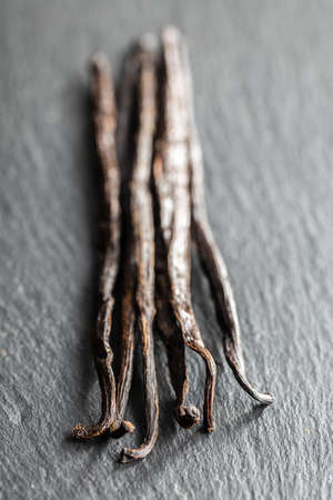 Vanilla pods. Sticks of vanilla on black table.の写真素材