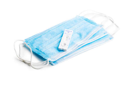 rapid antigen test. Rapid antibodies test kit and protective medical face mask isolated on white...