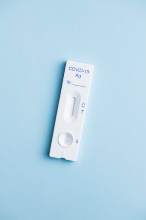 Covid-19 rapid antigen test. Rapid antibodies test kit on blue background. Top view.の写真素材