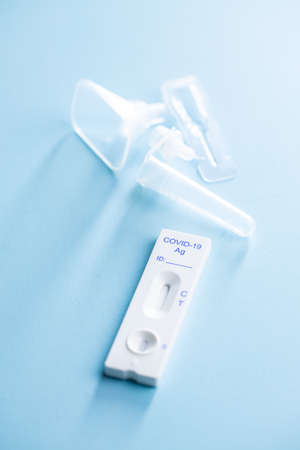Covid-19 rapid antigen test. Rapid antibodies test kit on blue background.