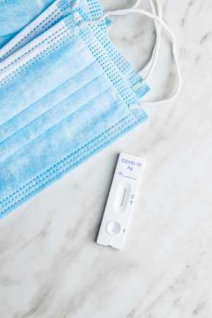 Covid-19 rapid antigen test. Rapid antibodies test kit and surgical face mask. Top view.