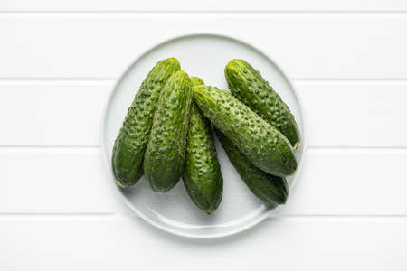 Fresh green cucumbers on white table.の写真素材