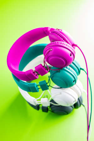 Coloful wired stereo headphones on green background.の写真素材
