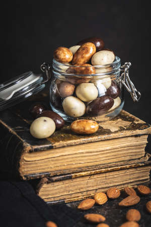 Sweet chocolate almonds. Chocolate eggs in jar.