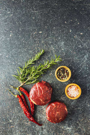 The raw beef meat steak on black table. Top view.の写真素材